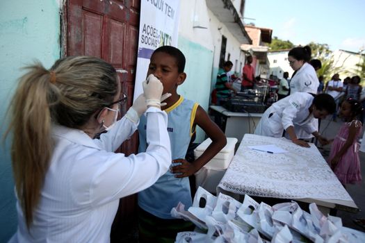 salvador, bahia, brazil - october 20, 2017:  dentita is tested in children's teething during social action in a daycare center in the city of Salvador.

