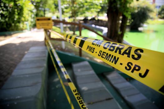 salvador, bahia, brazil - july 20, 2021: striped protective tape to isolate an area to prevent crowding of people in a park in the city of Salvador.
