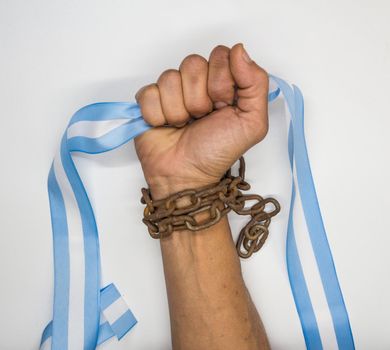Chain fist holding an Argentine flag. Argentine revolution and independence concept