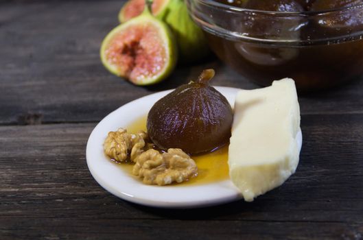 Figs in syrup . Dessert that is accompanied with fresh cheese and walnuts