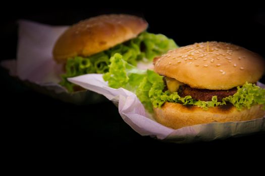 Burgers isolated on black background. Fast food.