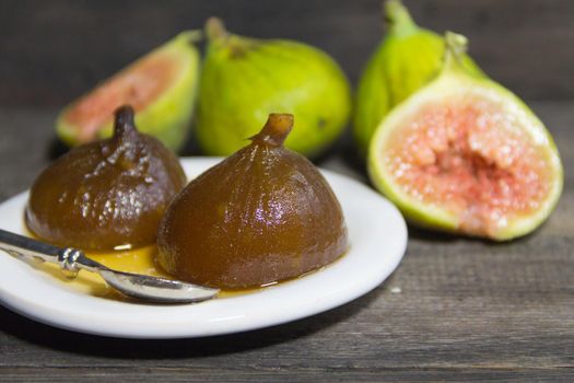 Figs in syrup . Dessert that is accompanied with fresh cheese and walnuts