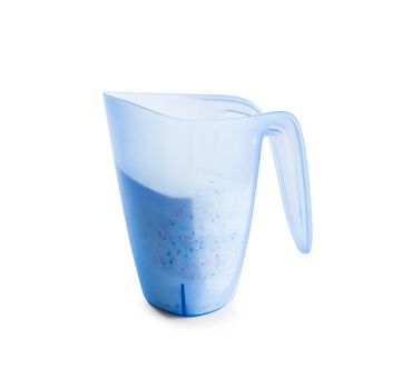 washing powder in a measuring cup on a white background