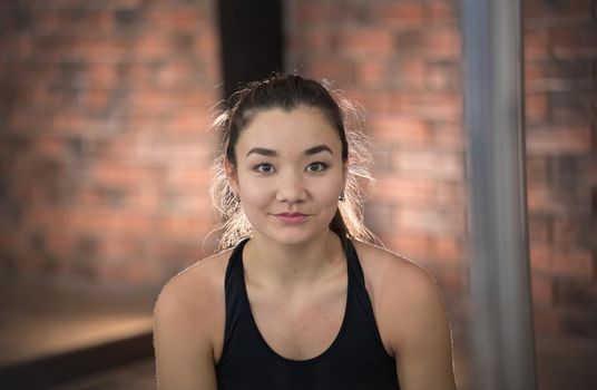 Young pretty woman in sport clothes. Looking in the camera. Portrait