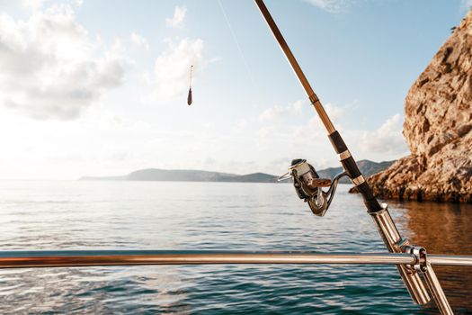 Fishing rod on a sailboat on the background of the open sea