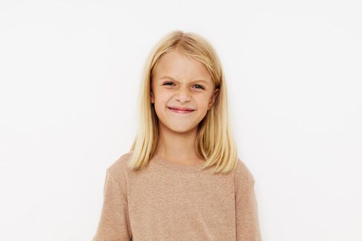 happy child in a beige t-shirt isolated background. High quality photo