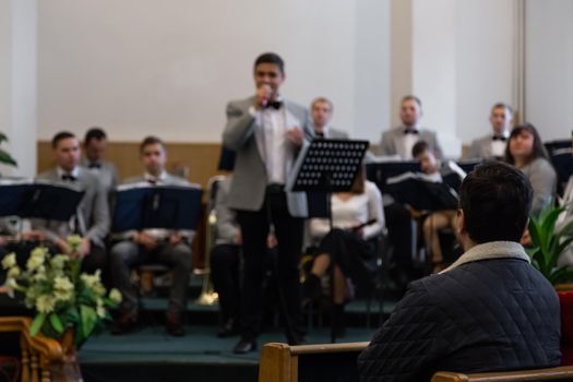 KOROSTEN - NOV, 10, 2019: Blurred photo. The view from the audience, people are listening to a young man singing solo