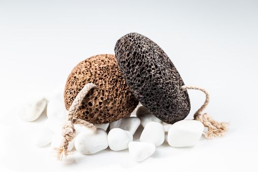 Brown and black pumice stone for home spa over white background