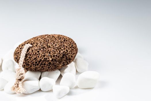 Brown pumice stone for home spa over white background