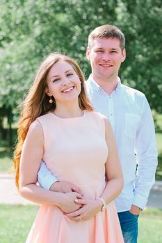 Happy young couple smiling at a nature park