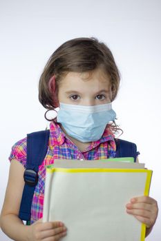 Kid school girl during pandemy going to school with a mask