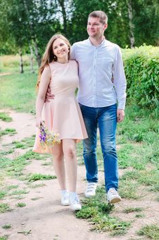 Lovely couple huggs and walks on the nature park