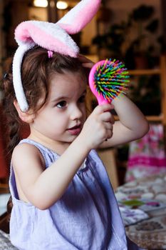 Little kid girl having fun with bunny ears on head
