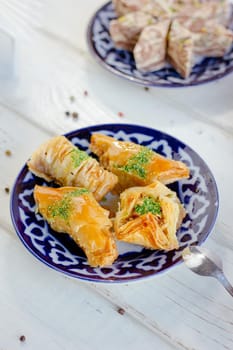 Asian dessert baklava or pahlava on a traditional oriental plate, great image for your needs.