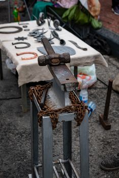 Metal hammer on the anvil - blacksmith equipment.