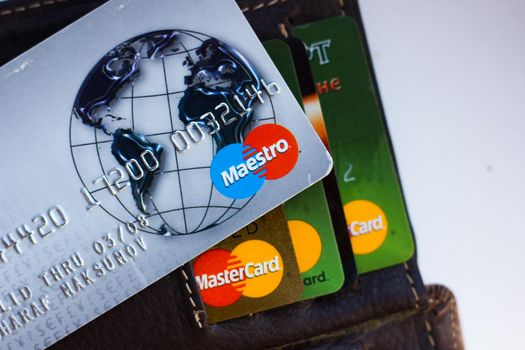 Ryazan, Russia - February 27, 2018: Credit card of Maestro brand over the leather wallet and number of cards