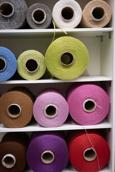 Cotton sewing threaded reels in a sewing shop.
