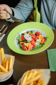 Kid eating salad, great image for your needs.