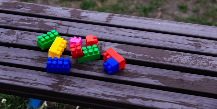 Colorful toy building blocks or bricks On wood background