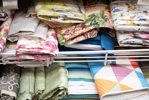 Rolls of fabric material in a textile shop.