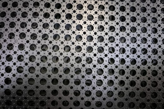 Perforated metal pattern background. Black and gray metal background