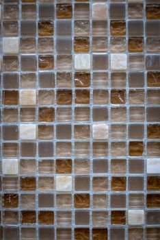 Brown ceramic mosaic on the wall as background.