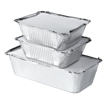 Packed foil food boxes on white background, copy space, close up