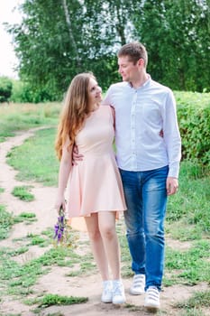 Lovely couple huggs and walks on the nature park