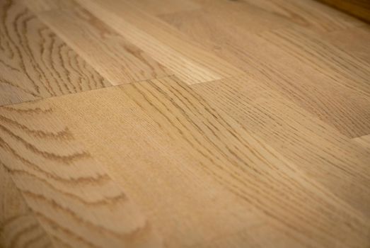 Dark brown wooden parquet floor texture as background.