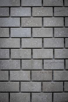 Gray ceramic bricks on the wall as background.