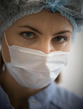 Specialist of cosmetology clinic in white protective mask. Portrait