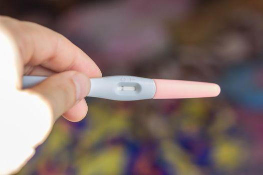 Negative pregnancy test over the color background