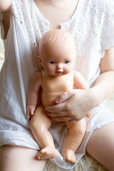 Little kid girl with the toy puppet or doll.