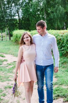 Lovely couple huggs and walks on the nature park