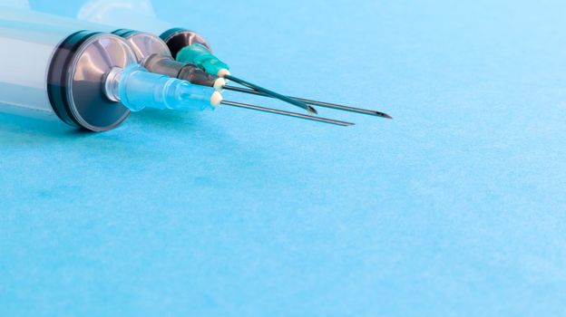 Three medical disposable plastic empty syringes with needles of different sizes and volumes. Vaccination concept, quarantine, self isolation, protection against coronavirus, medicine. copy space.