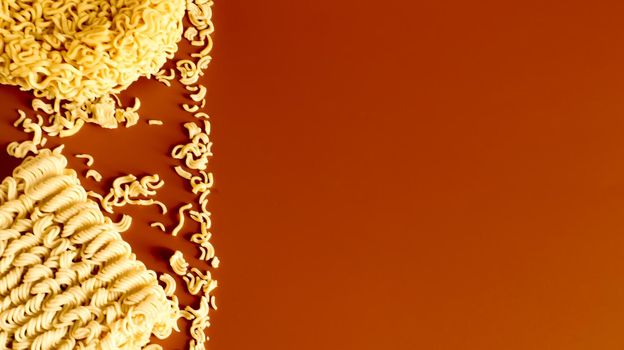Instant noodles asian ramen. Dry yellow raw food noodles. pasta, for the preparation of which it is enough to pour boiling water and wait a few minutes. Copy space korean and japanese vermicelli
