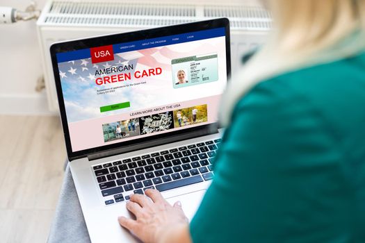 woman with laptop Permanent resident card Green card of USA.