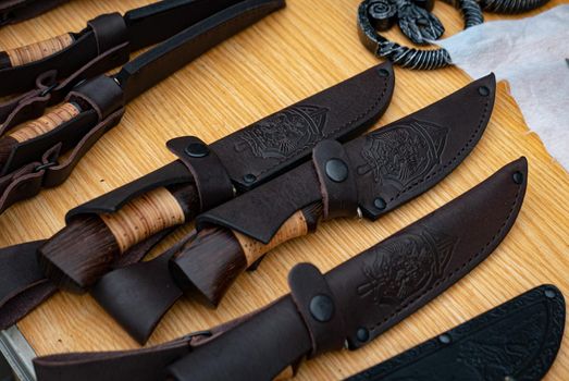 Ryazan, Russia - July 27, 2019: Knives in a leather case on a blacksmith festival