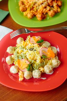 Fusilli pasta with meatballs and vegetables, great image for your needs.