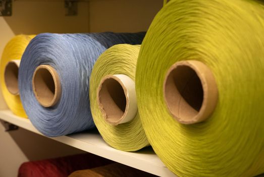 Green threaded cotton reel in a shop.