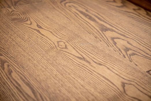 Dark brown wooden parquet floor texture as background.