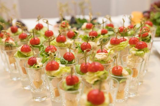 Triangular rows of cocktails with vegetables on the banquet table. Close up