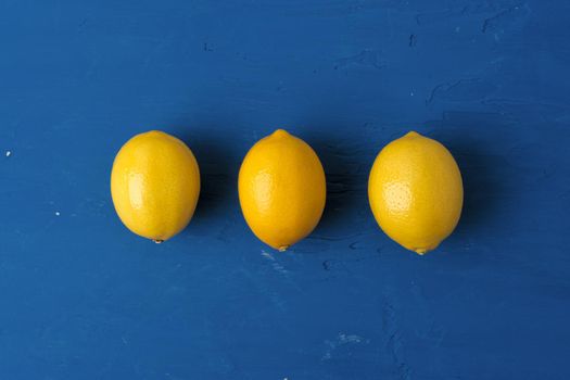 Lemon on classic blue background, top view. High quality photo