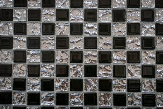 Gray ceramic mosaic on the wall as background.