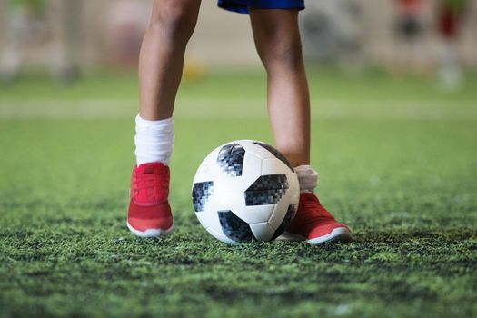 Traditional soccer ball on soccer field. Close up