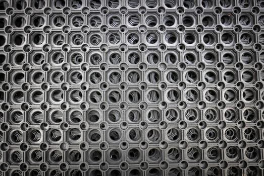 Perforated metal pattern background. Black and gray metal background