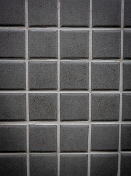 Gray ceramic mosaic on the wall as background.