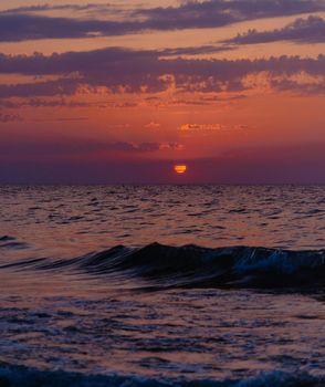 Nature background: beautiful sunset in red color over sea.