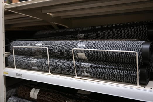 Rolls of doormats in a fabric shop.
