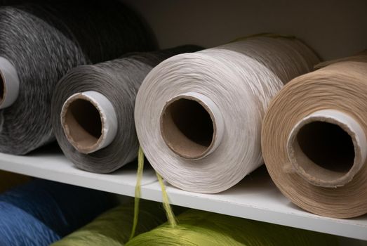 Cotton sewing threaded reels in a sewing shop.